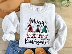 Celebrate the holiday spirit in style with our festive Kindergarten Teacher Christmas Sweatshirt! Perfect for spreading cheer in the classroom, this cozy sweatshirt features a delightful holiday design. Made from soft, high-quality fabric, it ensures warmth and comfort throughout the season. Ideal for teachers who want to showcase their love for teaching and the holidays, this sweatshirt is a must-have for festive school days and Christmas gatherings. Available in various sizes and colors to sui Winter School T-shirt With Letter Print, Winter Letter Print T-shirt For School, Long Sleeve Winter T-shirt For School, Long Sleeve T-shirt For School In Winter, Christmas Gift For Teacher, Teacher Sweatshirt, Gnome Christmas, Christmas Gathering, First Grade Teachers