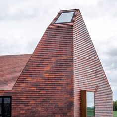 a red brick building with a skylight on top of it's shingled roof