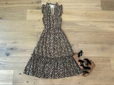 Step up your style game with our Something More Leopard Midi Dress! Featuring a fierce leopard print, playful ruffle details at the neckline and shoulders, and a self-tie belt for a personalized fit. Lightweight and versatile, easily dress it up with wedges or go casual with flats. Layer with a denim jacket or blazer for added coverage. Dress is fully lined. Dress measures 46"in length. Bust measures 21" from underarm seam to seam. Measurements taken on a small. Fabric has no stretch. This has a Fall Leopard Print Knee-length Midi Dress, Chic Leopard Print Knee-length Midi Dress, Skirt Extender, Fitted Leopard Print V-neck Midi Dress, Casual Leopard Print V-neck Midi Dress, Deodorant Stains, Leopard Print V-neck Beach Dress, Belt Tying, Scarf Hat