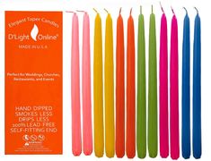 eight bright colored candles are lined up next to each other with the package in front