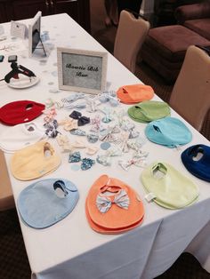 a table topped with lots of different colored bibs