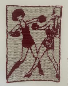 a crocheted square with a woman and man on it, in the shape of a cross - stitch pattern