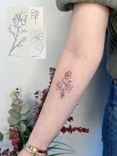 a woman's arm with a flower tattoo on the left side of her arm