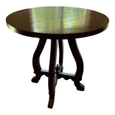 a wooden table with an oval shaped top