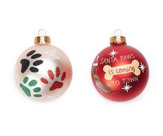 two christmas ornaments with dog paw prints and santa paws is coming to town written on them