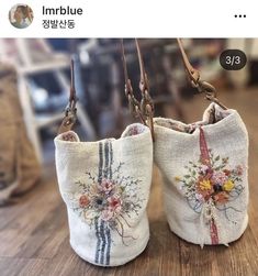 two purses with flowers on them sitting on a table