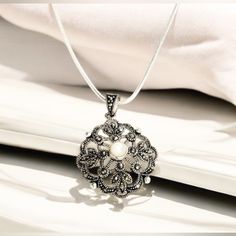 This Is Such A Pretty Necklace! It Is: Black Rhinestones Throughout Pendant Pearl In The Center Of The Pendant 100% Authentic Sterling Silver Stamped Length: 24" (12" When Done Up) Size Of Pendant: 1" X 1" Comes With A Small Thank You Gift! Will Be Beautifully Wrapped In A Box With Ribbon As Shown In Pictures. I Take Great Pride In What I Sell And Stand Behind Each Item. I Want My Buyers To Love What They Receive From Me. I Love Offers And To Bundle Items. Just Message Me Elegant Antique Silver Round Necklace, Elegant Antique Silver Necklace With Silver Beads, Elegant Necklace With Silver Beads And Round Pendant, Small Thank You Gift, Box With Ribbon, Pretty Necklace, Womens Jewelry, Pretty Necklaces, Jewelry Sterling Silver