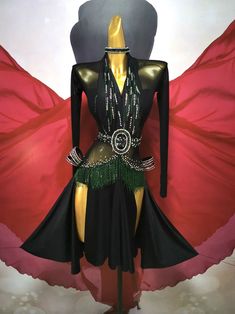 a mannequin wearing a black and green dress with chains on it's waist