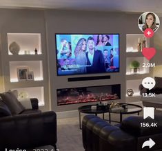 a living room filled with furniture and a flat screen tv mounted on the wall above a fire place