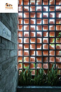 the entrance to an office building with plants growing out of it