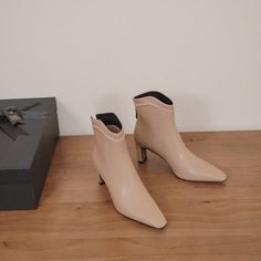 Looking for the perfect pair of shoes to transition from summer to fall? These nude ankle boots are just what you need! Made with a square toe and 2'' heel. they are both stylish and comfortable. The leather material is also perfect for pairing with any outfit.  Upper: Leather Lining: Leather Outsole: TPR Toe: Square Toe Heel: 7cm/2.8'' Closure: Zip Color: Nude. Burgundy is_handmade: Yes The above measurement is based on size 6. with one size larger. 0.5cm wider. Beige Heeled Boots With Sculpted Block Heel, Beige Ankle Boots For Office, Trendy Beige Boots For Work, Trendy Beige Boots For Workwear, Elegant Spring Mid-calf Boots With Sculpted Heel, Elegant Mid-calf Boots With Sculpted Heel For Spring, Chic Cream Heeled Boots With Block Heel, Elegant Beige Mid-calf Boots For Spring, Trendy Beige Leather Heeled Boots