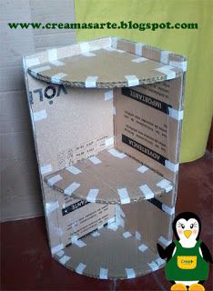 a penguin is standing next to a cardboard box that has some paper on it and an envelope in the bottom