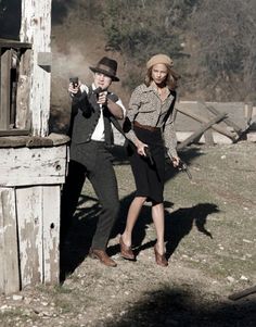 a man and woman dressed in old fashioned clothing