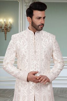 This men's sherwani, R14-S91, features a Double-layer design specifically crafted for grooms. The traditional thread embroidery and stone accents add an elegant touch to any wedding outfit. Experience the comfort and sophistication of this expertly crafted sherwani. Wedding Sherwani With Chikankari Embroidery In Traditional Fit, Embroidered Traditional Fit Sherwani For Wedding, Transitional Sherwani With Intricate Embroidery, Traditional Fit Long Sleeve Sherwani For Wedding, Traditional Fit Long Sleeve Wedding Sherwani, Groom's Kurta With Intricate Embroidery, Cream Bandhgala For Transitional Season, Groom's Kurta With Intricate Embroidery For Diwali, Embroidered Sherwani For Groom In Transitional Season