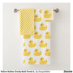 two yellow rubber ducky bath towels hanging on a towel rack