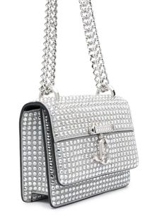 Find JIMMY CHOO Crystal-embellished Mini Bag on Editorialist. This Jimmy Choo mini bag is crafted from silver-tone calf leather and features glass crystal embellishments. It has a monogram plaque, a foldover top with a magnetic fastening, and an adjustable chain-link shoulder strap. The bag features a main compartment and an internal zip-fastening pocket. It can be worn on the shoulder or crossbody. Glamorous Leather Embellished Bags, Designer Silver Embellished Shoulder Bag, Glamorous Embellished Leather Bags, Luxury Shoulder Bag With Rhinestones, Luxury Rhinestone Shoulder Bags, Luxury Embellished Shoulder Bag For Shopping, Designer Embellished Bags For Shopping, Luxury Rhinestone Bags For Shopping, Designer Embellished Crossbody Bag