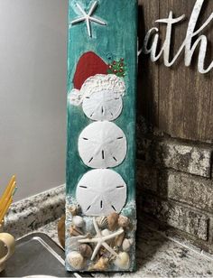 a clock made out of sand sitting on top of a counter next to a sign