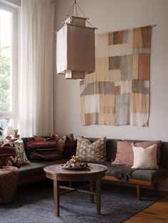 a living room filled with furniture and pillows