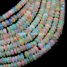 multicolored opal glass beads with white and green speckles on black background