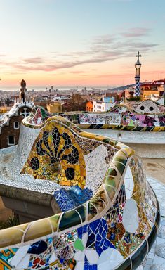 an artisticly designed bench on top of the roof of a building in barcelona, spain