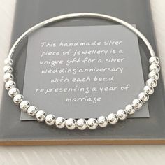 this handmade silver piece of jewelry is a unique gift for a silver wedding anniversary with each bead represents a year of marriage