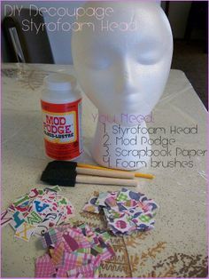 a white mannequin head sitting on top of a table next to craft supplies