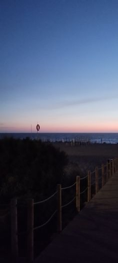 the sun is setting at the beach with no one in sight or any other person