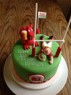 a green birthday cake with red and white decorations