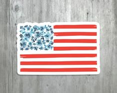 an american flag sticker with paw prints on the bottom and red, white, and blue stripes