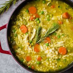 a pot filled with soup and vegetables on top of a table