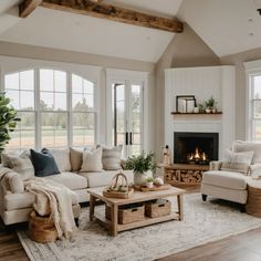 a living room filled with furniture and a fire place in the middle of a room