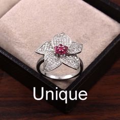 Vintage Ruby Moissanite Ring, Stylish Design Gemstone Ring, 2nd Anniversary Ring, Moissanite Bridal Silver Ring, Ruby Girlfriend Ring, Gift. Center Gemstone : Rare Pink Ruby Side Gemstone : Rare VVS1 Moissanite Gemstone Shape : Round Gemstone Size : 1.50mm Material: 925 Sterling Silver  Stone information Moissanite gemstones may promote cardiovascular health and lower cholesterol levels. Some people use the stone to increase their strength and stamina. Moissanite is thought to boost female fertility and reduce stress during pregnancy. Shop Information   Add this beautiful Ring in your accessories to make you feel unique. This ring have 925 stamp and you will receive a ring like the one in the picture. You can choose any size you want from drop down menu. We Accept Custom Order and Bulk Ord Luxury Ruby Flower Ring For Gift, Flower Shaped Cubic Zirconia Gift Ring, Elegant Flower Shaped Ruby Promise Ring, Elegant Flower-shaped Ruby Promise Ring, Flower Shaped Diamond Ring With Accents For Gift, Flower-shaped Diamond Ring With Accents As Gift, Flower Shaped Diamond Ring With Diamond Accents, Flower Shaped Diamond Ring With Accents, White Gold Flower Ring With Vvs Clarity For Gift