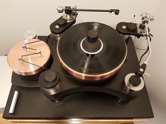 an old record player sitting on top of a table