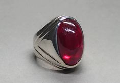 Cabochon Ruby 925 Sterling Silver Handmade Ring 𝐏𝐫𝐨𝐝𝐮𝐜𝐭 𝐓𝐲𝐩𝐞: Ring 𝐑𝐢𝐧𝐠 𝐒𝐢𝐳𝐞𝐬: 5 US, 6 US, 7 US, 8 US, 9 US, 10 US, 11 US, 12 US, 13 US, 14 US, 15 US, 16 US 𝐌𝐞𝐭𝐚𝐥 𝐓𝐲𝐩𝐞: 925 Sterling Silver 𝐆𝐞𝐦𝐬𝐭𝐨𝐧𝐞: 30 Carat Ruby, Yaqoot 𝐆𝐞𝐦𝐭𝐨𝐧𝐞 𝐂𝐨𝐥𝐨𝐫: Red, Pink Ruby, Red Ruby, Lal Yaqoot 𝐓𝐲𝐩𝐞: 𝐓𝐲𝐩𝐞: Heated & Treated (Lab-Created) Rubies, the birthstone of July, are considered the king of gems and represent love, health, and wisdom. It was believed wearing Formal Polished Red Ruby Ring, Formal Red Ruby Ring With Polished Finish, Modern Red Cabochon Ring, Classic Sterling Silver Cabochon Ruby Ring, Classic Sterling Silver Ruby Ring With Cabochon, Formal Cabochon Ruby Ring In Sterling Silver, Red Oval Cabochon Signet Ring For Formal Occasions, Red Gemstone Dome Ring, Classic Red Oval Cabochon Signet Ring