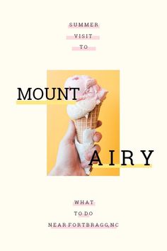 a hand holding an ice cream cone with the words mount airy above it and below it