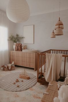 a baby's room with a crib, dresser and bed