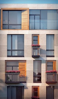 an apartment building with balconies and flowers on the balconies are shown