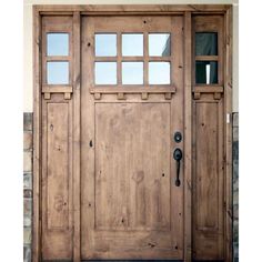 the front door is made from wood and has glass panels