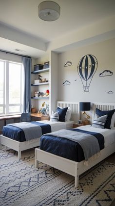 two twin beds in a bedroom with blue and white decor