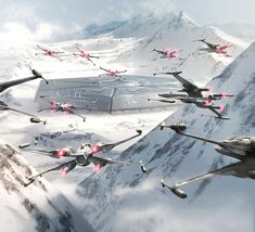 a group of fighter jets flying over a mountain