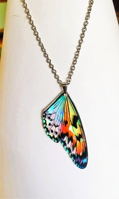 Beautiful holographic monarch butterfly pendant suspended on your choice of a stainless steel 16-19inch cable chain or an 18 inch black jewelry cord. both with a lobster clasp closure.  As seen in the photos, the butterfly wings take on different colors depending on the light that is reflected on the many facets and the pendant is 1/16 of an inch thick acrylic and very light weight.  Your necklace will arrive in a gift box.  To see the Fairy wing necklaces, or matching butterfly earrings please Iridescent Jewelry With Adjustable Chain For Gift, Adjustable Metal Butterfly Necklace For Gifts, Adjustable Metal Butterfly Necklace Gift, Iridescent Butterfly Jewelry For Gift, Iridescent Butterfly Jewelry For Gifts, Multicolor Adjustable Butterfly Necklace For Gift, Adjustable Multicolor Butterfly Necklace For Gift, Adjustable Multicolor Butterfly Necklace Gift, Iridescent Butterfly Shaped Jewelry Gift