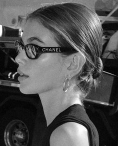 a woman wearing sunglasses with the word chanel written on her side in front of her face