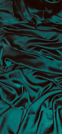 the dark green fabric is very soft and shiny, it looks like silk or satin