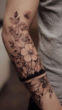 a man with a flower tattoo on his arm