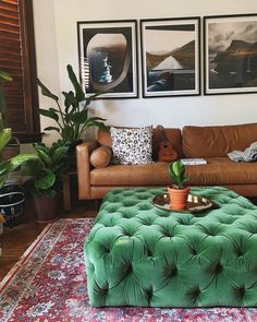 a living room filled with furniture and pictures hanging on the wall above it's coffee table