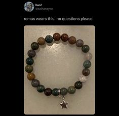 a bracelet with a star charm on it, and the words remus wears this no questions please