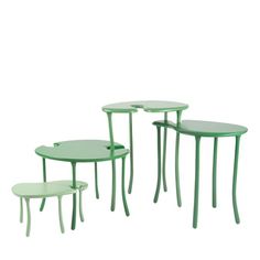 three green tables and two stools are shown in this image, the table has four legs