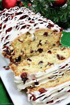 a cake with white frosting and cranberry toppings sitting on a plate