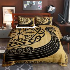 a bed covered in a black and gold comforter