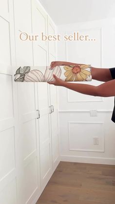 a woman is opening the closet door with her hand and holding it up to show what's inside